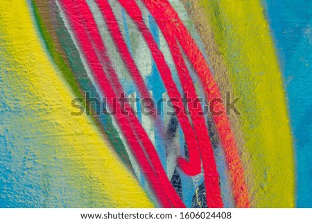 Beautiful bright colorful street art graffiti background. Abstract geometric spray drawing fashion colors on the walls of the city. Urban Culture detailed close up texture red, yellow ,blue picture
