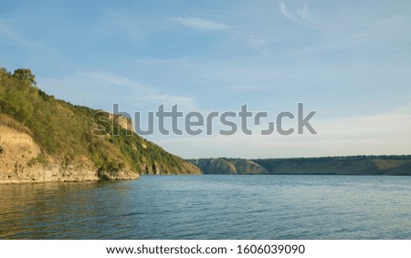 north European Norway nature landscape scenic view in spring time lake peaceful water surrounded by green mountains and hills, clear sky background with empty copy space 