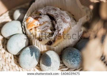 Easter cake and colored pastel eggs on the rattan napkin background. Beautiful light blue eggs. Easter background. Happy Easter concept. Thrush eggs.