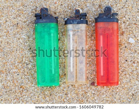colorful  Lighters on the sea beach texture The concept of plastic waste causes global worming concept