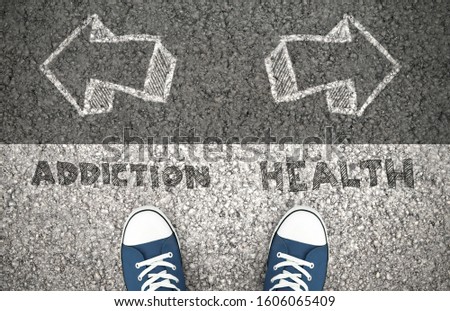 Recovery Concept, Addiction Or Health Written On The Asphalt Road. Above view of feet on the ground Royalty-Free Stock Photo #1606065409