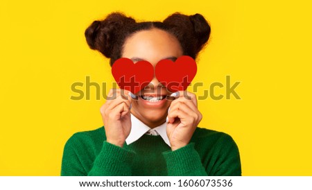 Smiling Young African American Woman Holding Hearts In Front Of Eyes. Panorama, copy space