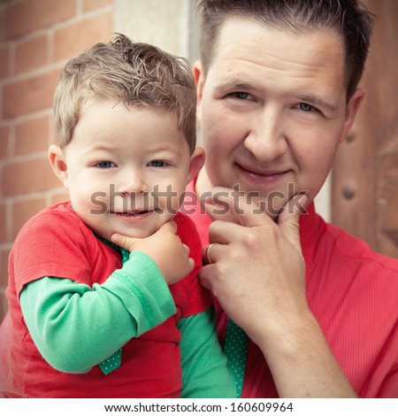 Father and son in the same pose Royalty-Free Stock Photo #160609964