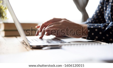 Female hands of business woman professional student using laptop sit at home office desk typing on computer keyboard study work with pc software tech concept, online job and education, close up view Royalty-Free Stock Photo #1606120015