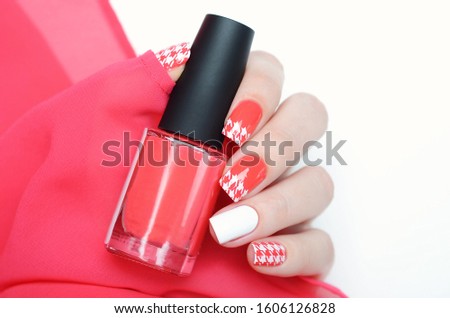 Red manicure with a white pied-de-poule houndstooth print