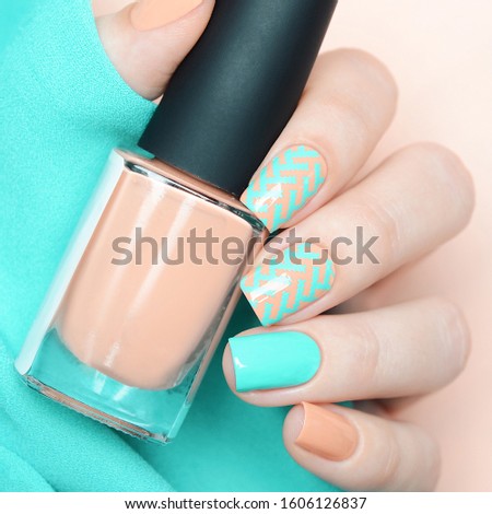 Pastel manicure peach and blue with zigzag pattern with fabric