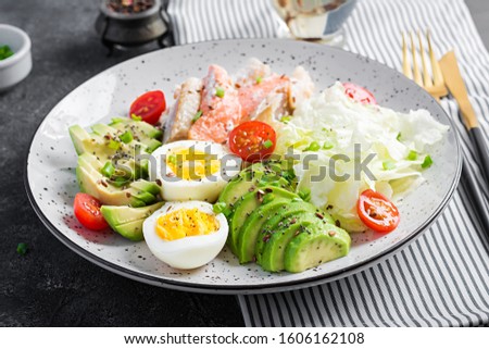 Ketogenic diet, breakfast. Eggs, fish and avocado, lettuce and seeds. Low carb high fat breakfast. Keto/paleo menu. Royalty-Free Stock Photo #1606162108