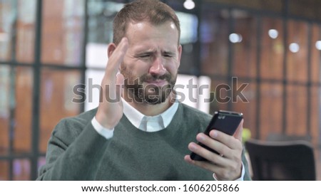 Portrait Shoot of Disappointed Man using Smartphone 