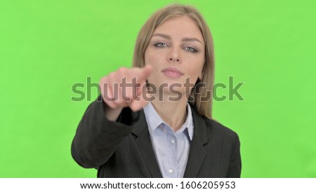 Cheerful Young Businesswoman Pointing Finger against Chroma Key