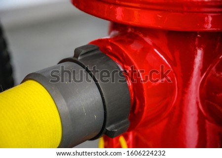 Fire hydrant with 2 1/2 inch flexible water hose connected