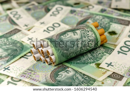 Polish 100 zl banknotes and cigarettes - excise concept