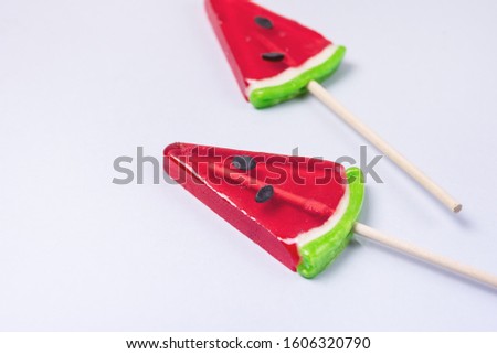 Two Tasty Red Lollipops in Shape of Watermelon on Blue Background Minimal Horizontal Tasty Candies