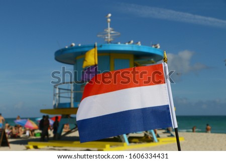 Beautiful National Flag of the Netherlands on Tropical Beach