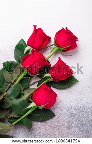 Red roses flowers on stone background. Valentine's greeting card. Top view. Copy space - Image