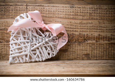 White wooden heart and wooden  background.