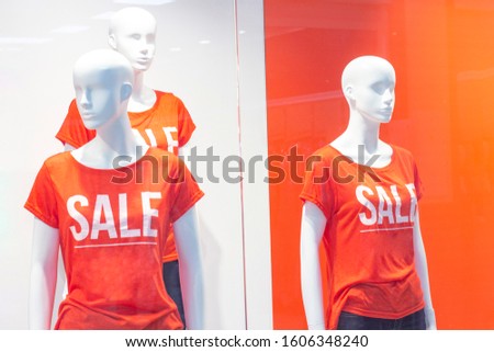 Part of a female mannequin dressed in casual clothes with the text sale in a shopping department store for shopping, fashion and advertising concepts.