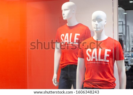 Part of a male mannequin dressed in casual clothes with the text sale in a shopping department store for shopping, fashion and advertising concepts. place for text
