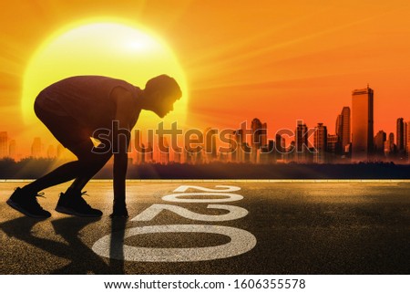 Man fitness silhouette at sunset, Jogging workout wellness, Happy New Year 2020 concept. - Image