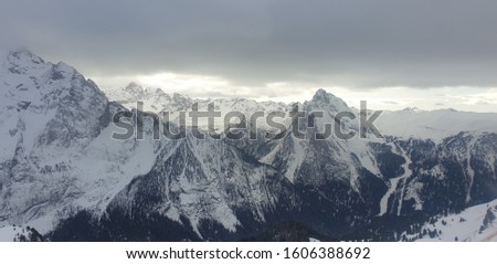 Snow-white Mountains under a cloudy sky