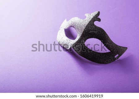 A festive, colorful group of mardi gras or carnivale mask on a purple background. Venetian masks.