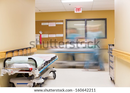 Blurred motion of nurses walking in hospital corridor