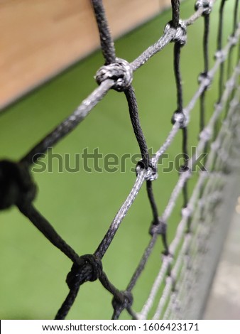 cricket practice net with green mat in background 
