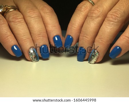 stylish blue manicure with a festive golden design.
