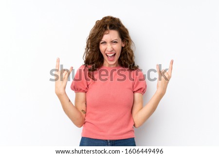 Young pretty woman over isolated background making rock gesture