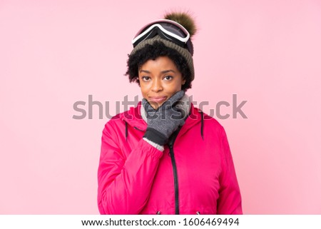 African american skier woman with snowboarding glasses over isolated pink background thinking an idea