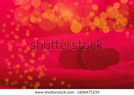 Greeting Card for Valentine's Day. Red hearts on red background bokeh. Copy space