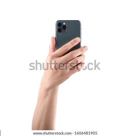 Female hand holding and touching on mobile smartphone show back side. Royalty-Free Stock Photo #1606481905