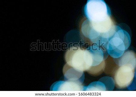 Blured lights of Christmas tree on the night street. 