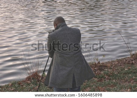 Photographer taking pictures at the lake