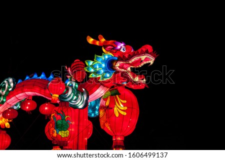 Traditional colorful chinese lion over black background.  Chinese New Year greeting card template. Minimalism, place for text, close up.
