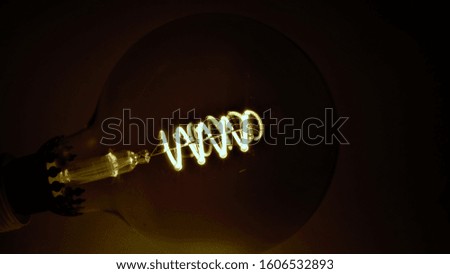 Vintage led light bulb macro photo of an incandescent spiral.