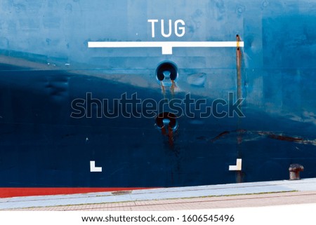Painted tug area sign on ship hull.