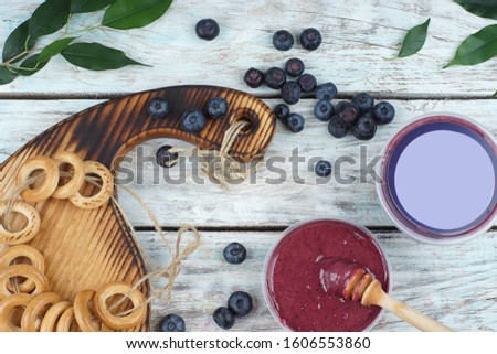 Blueberries and bagels tied with twine on the table, Next to whipped honey in a jar and copy space for your text and advertising, top view