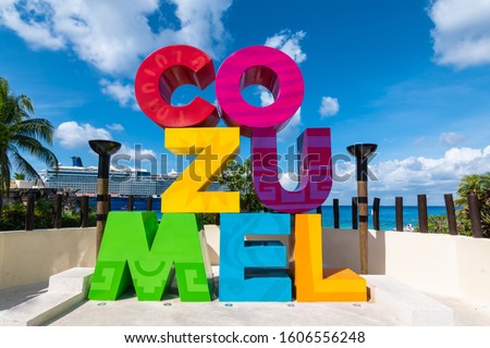Colorful word sign along the street in Cozumel, Mexico.  Cruise ship on the background. 