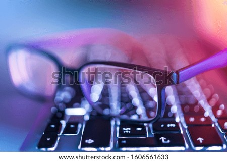 Simple glasses on laptop computer keyboard