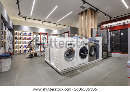 Washing machines and vacuum cleaners in the premium home appliance store Royalty-Free Stock Photo #1606585306