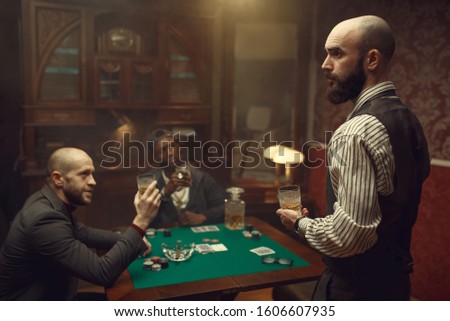 Three poker players sitting at the table, casino
