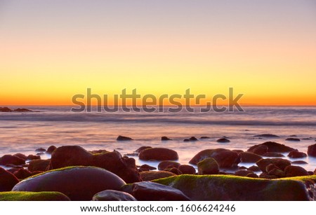 Beautiful sundown over the sea with water in motion blur -- Sunset seascape. Atlantic ocean, Tenerife island