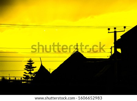 silhouette of ancient structures under power lines