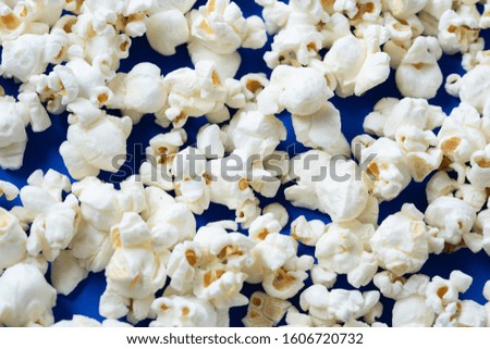 Closeup White salty popcorn on classic blue background