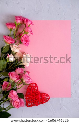 Valentine's Day background. Roses on pastel pink background  and a red heart. Valentines day concept. Flat lay, top view, copy space.   Royalty-Free Stock Photo #1606746826