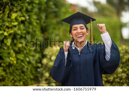Portrait of a female student on graduation day. Royalty-Free Stock Photo #1606755979