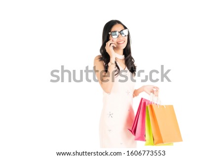  Asian woman is carrying a high quality shopping bag.
While working and watching cameras separately on a white background, business marketing concept