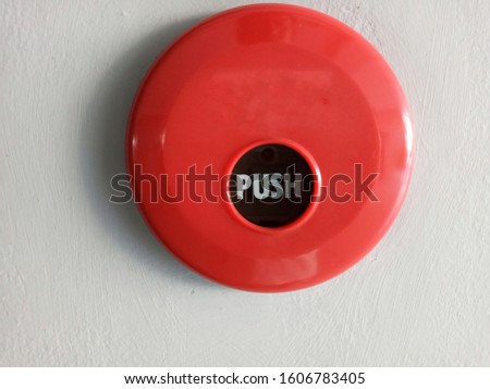 Red color fire alarm on wall.