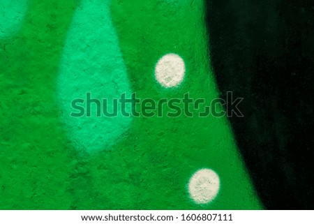 Beautiful bright colorful street art graffiti background. Abstract creative spray drawing fashion colors on the walls of the city. Urban Culture, black , white , green, blue, purple texture