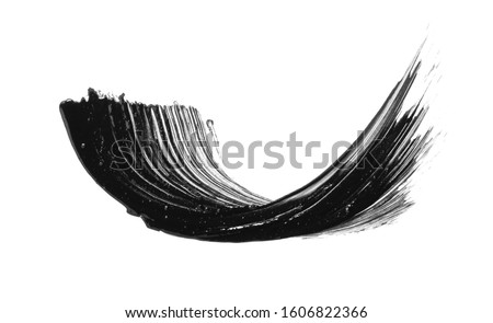 Black mascara brush stroke smear smudge isolated on white background. Makeup swatch. Cosmetic product creamy texture